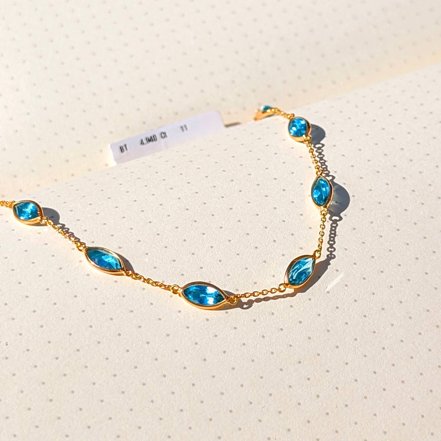Aqua Flow – 18K Marquise Blue Topaz Bracelet