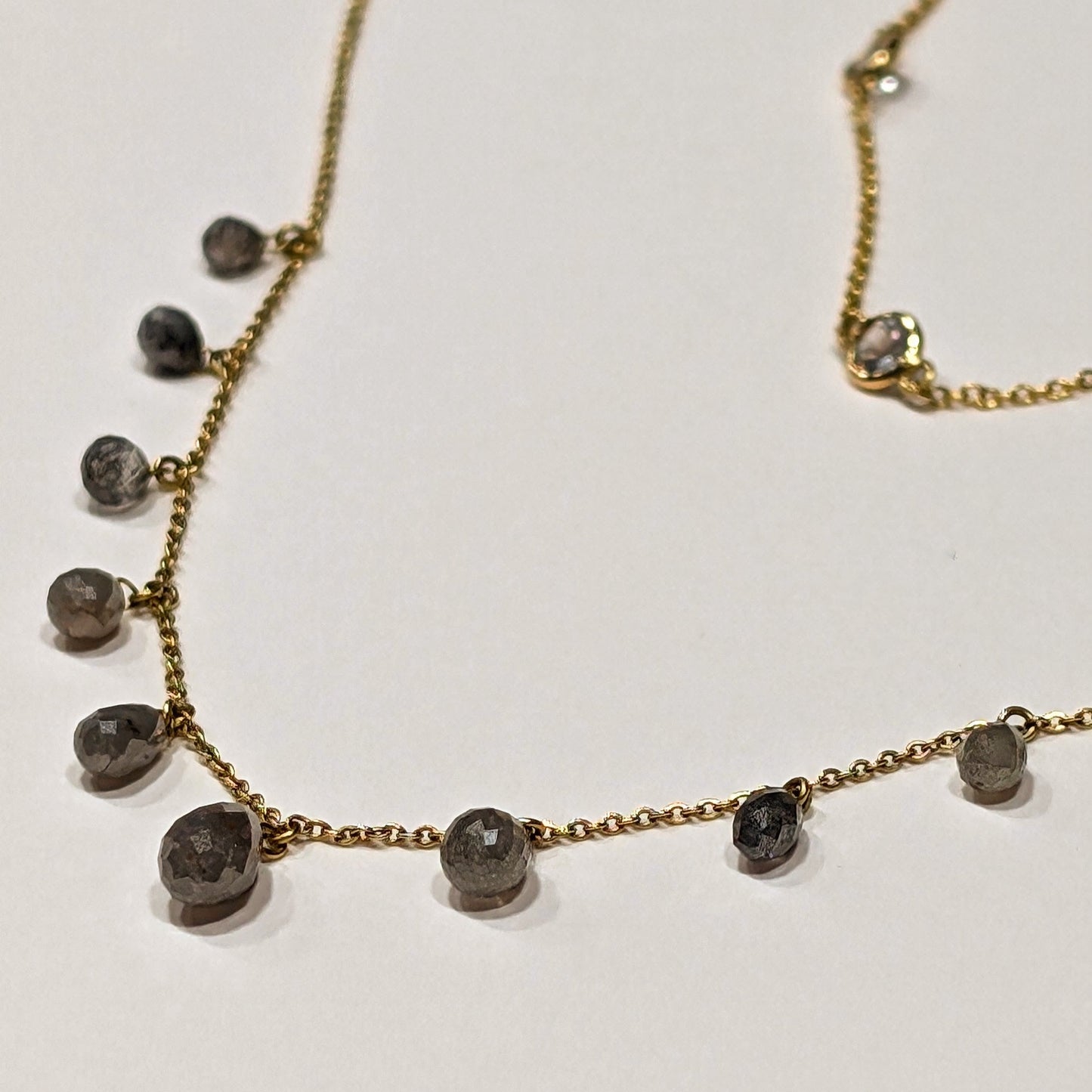 Necklace with small round beads on a light background