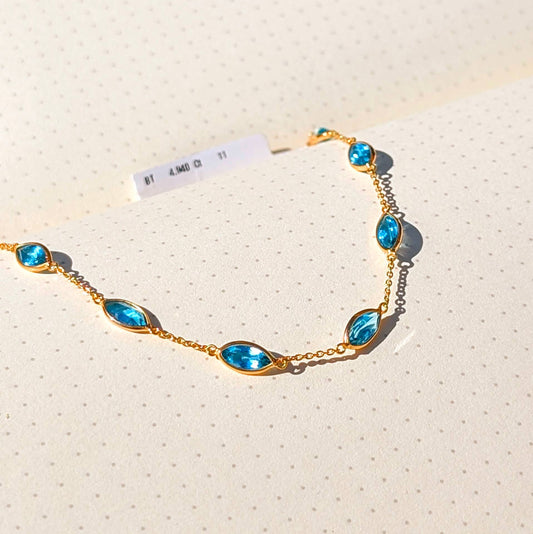 Aqua Flow – 18K Marquise Blue Topaz Bracelet
