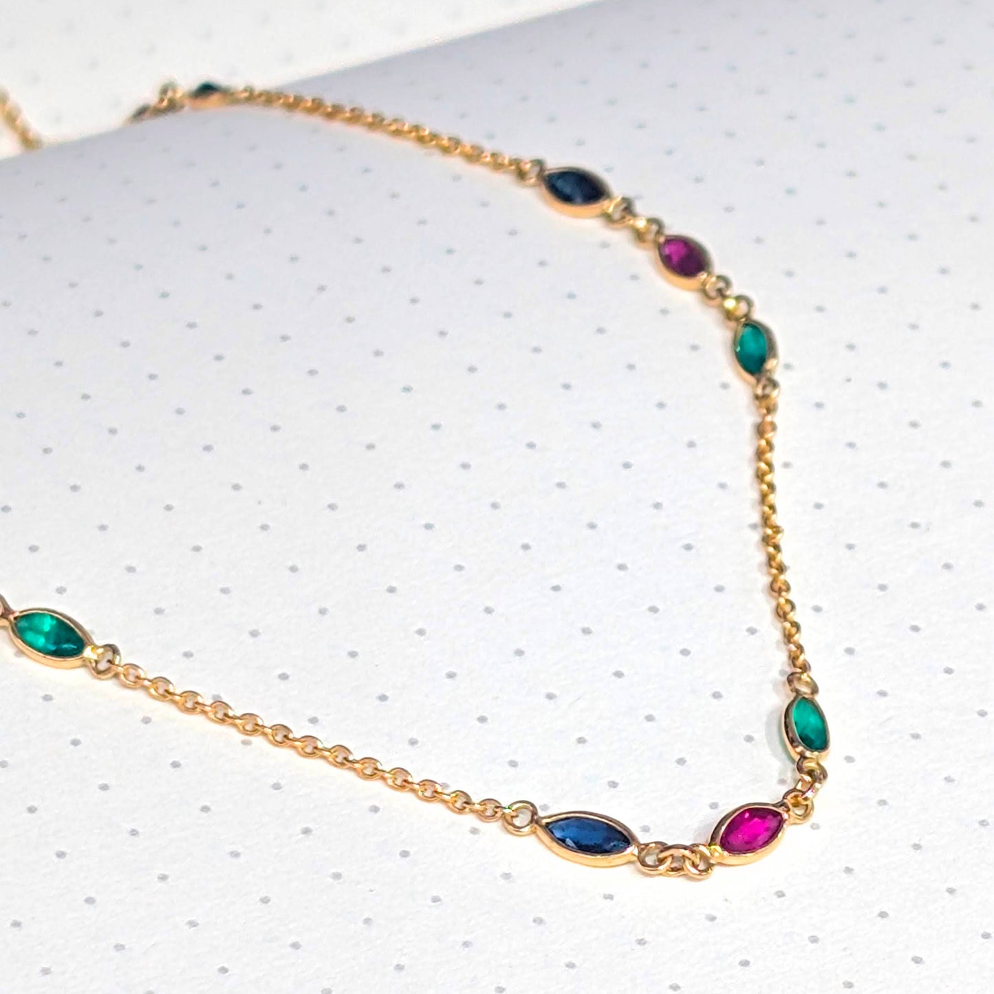 Necklace with multicolored gemstones on a white background