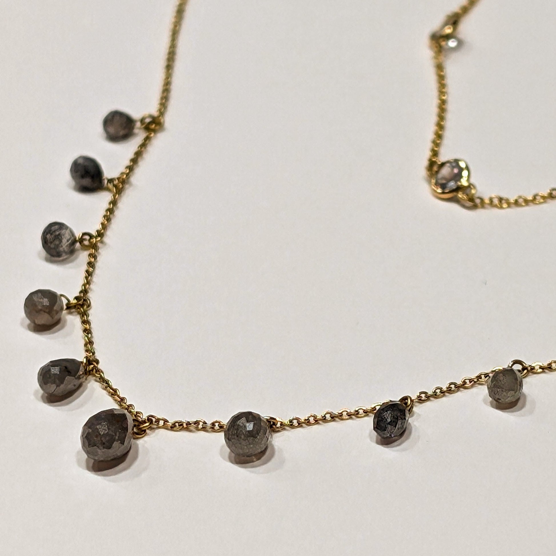 Necklace with small round beads on a light background