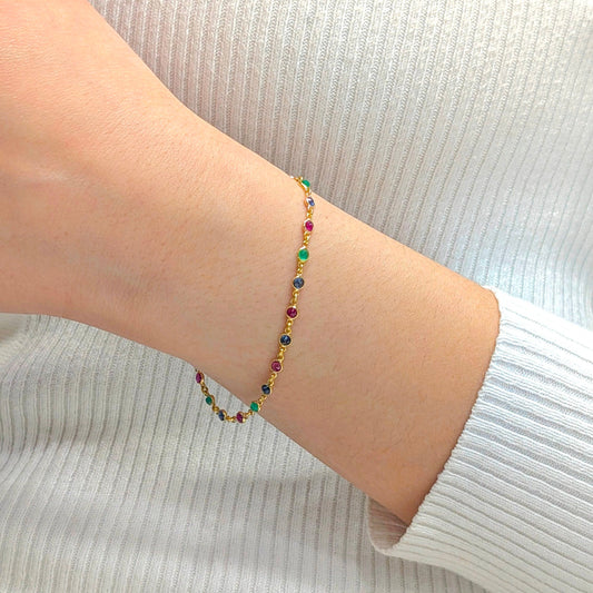 Colorful beaded bracelet on a person's wrist with a light background