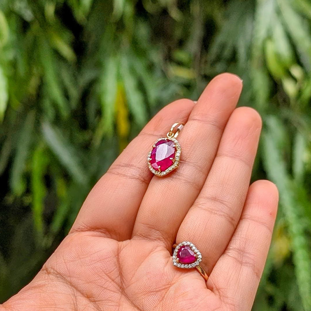 pendant showcases a stunning oval-shaped ruby of exceptional colour and clarity, set in solid 18K gold and framed by a halo of VVS, G-colour diamonds